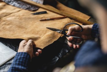 Closeup Of Craftsman Cutting Leather Handicraft